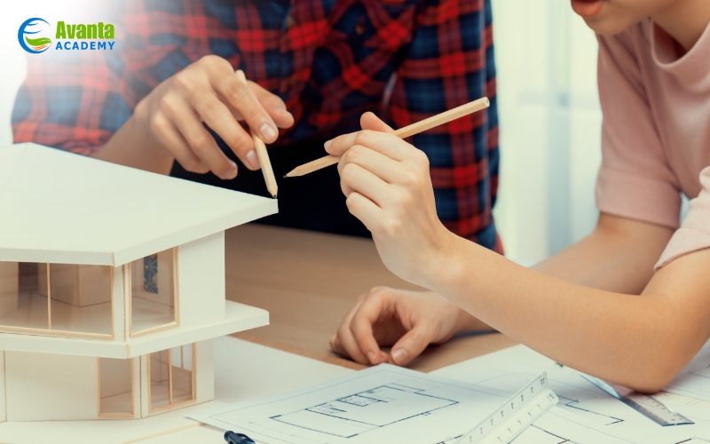 two people working on a 3D house model